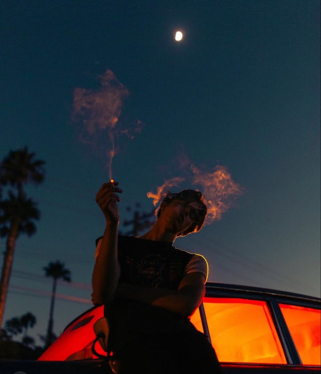 Mood reference of a person beside a car under a California night sky.