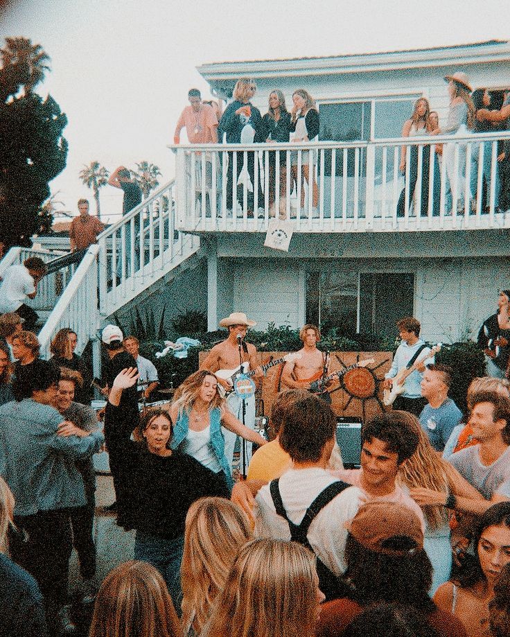 A daytime house show with friends watching from the balcony and courtyard.